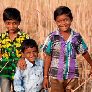 Rural boy enjoying together in the field, India.